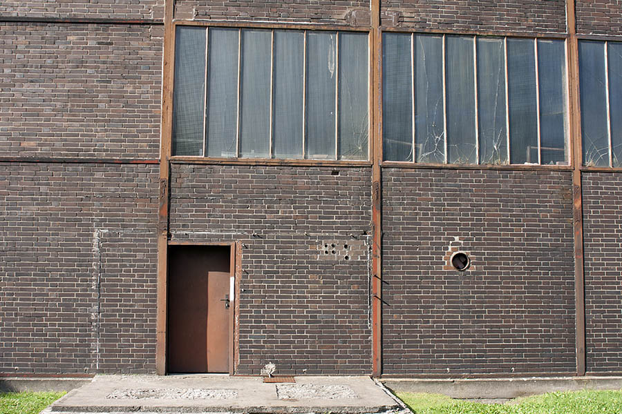Photo 00050: Worn, brown metal door and windows facade