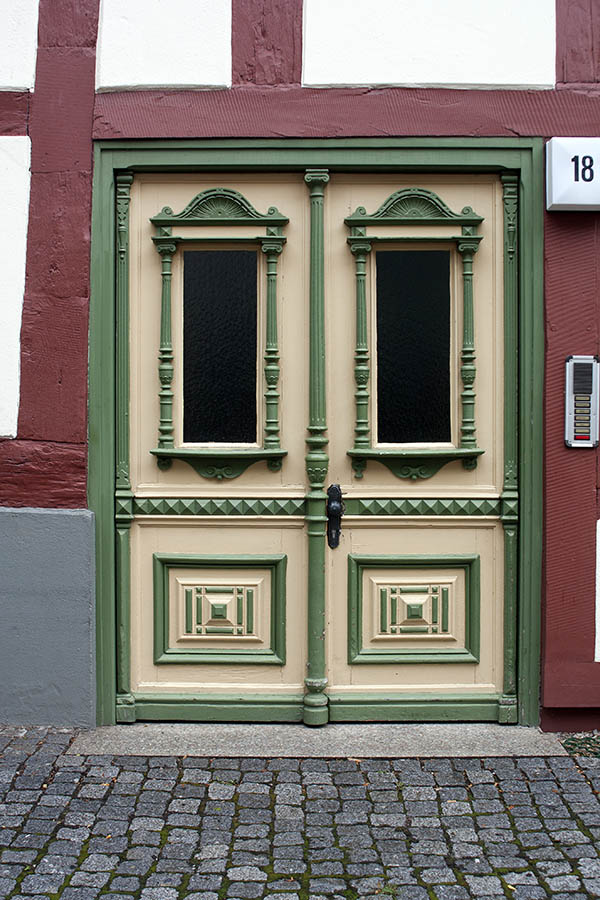 Photo 00231: Panelled, carved double door in green and light yellow colours