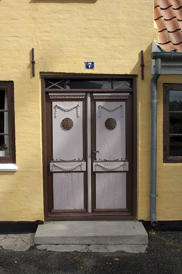 Photo 00437: Panelled, carved, brown and white double door with top window