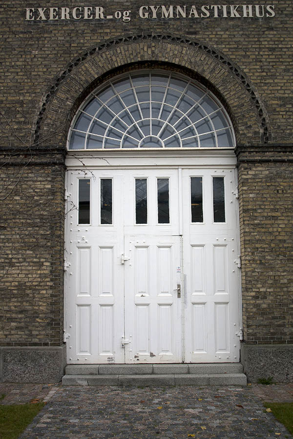 Photo 01410: Large, panelled, formed, white gate with minor door and fan light