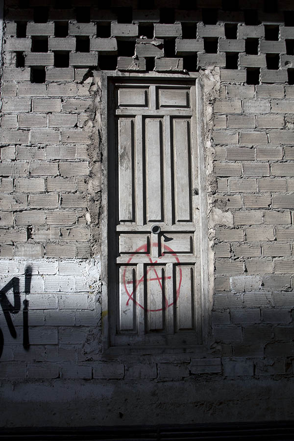 Photo 03326: Grey, panelled door in a rough wall