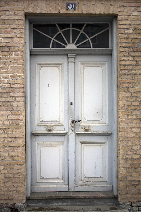 Photo 03876: Worn, panelled double door in white and grey with top window