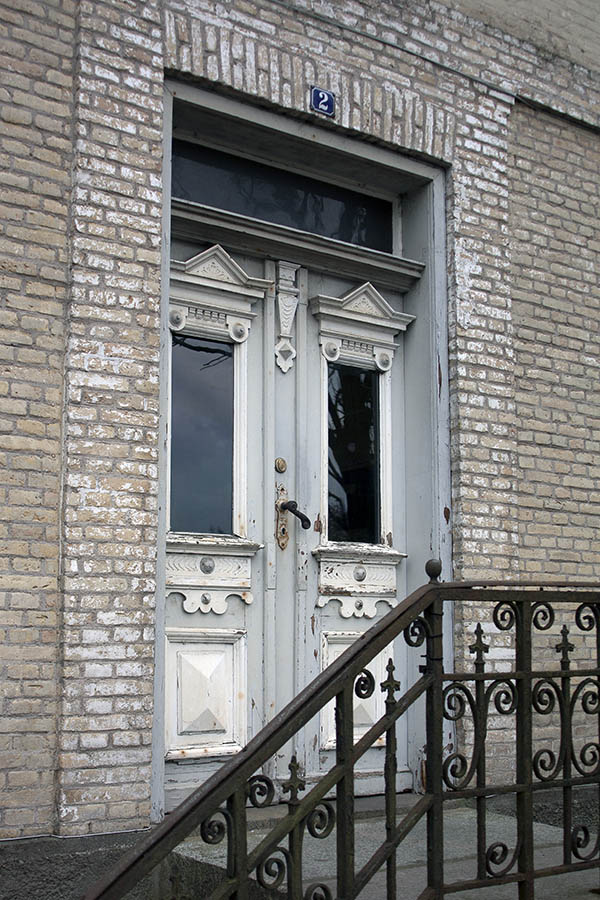 Photo 03997: Worn, panelled double door in white and grey with top window