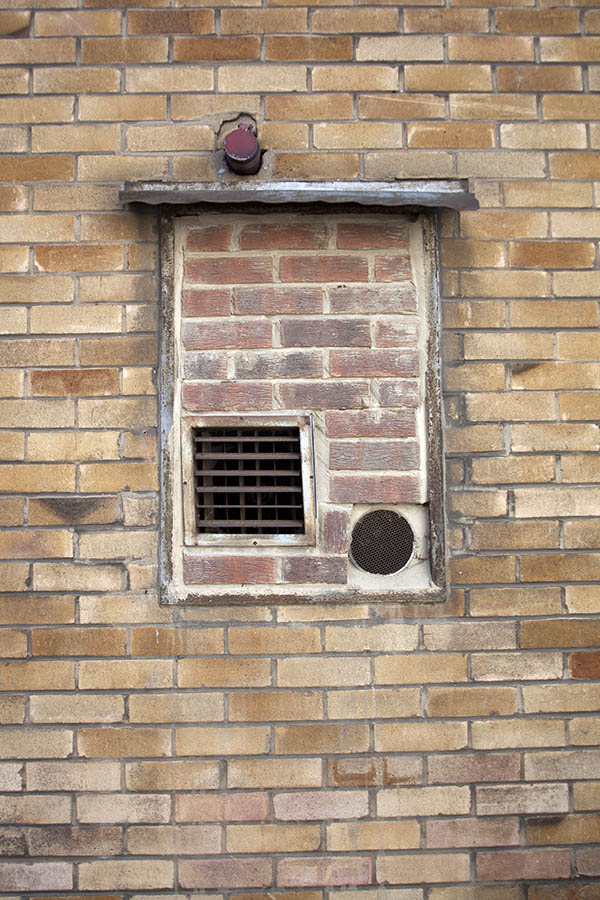 Photo 04889: No window. Three air gratings in an unpainted, former window.