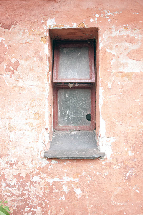 Photo 06314: Little, worn, red metal window with two frames