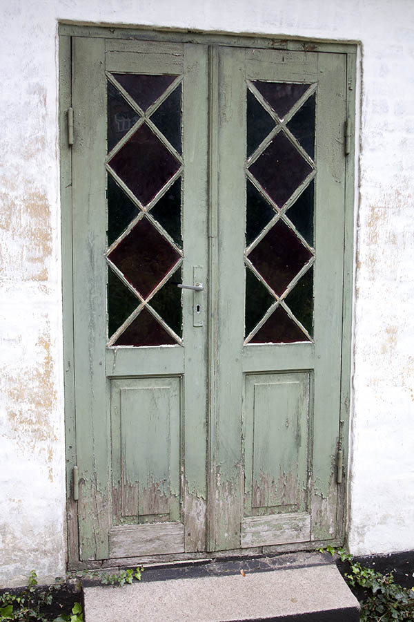 Photo 07372: Worn, panelled, light green double door with door light