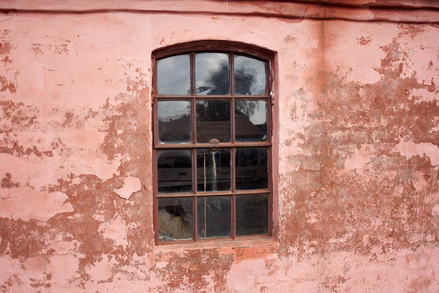 Photo 07739: Formed, rusty, brown metal stable window