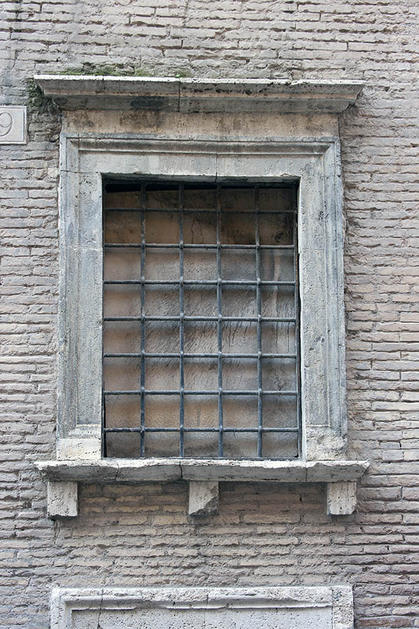 Photo 08121: No window. A grey, barred embrasure in a sandstone pilaster.