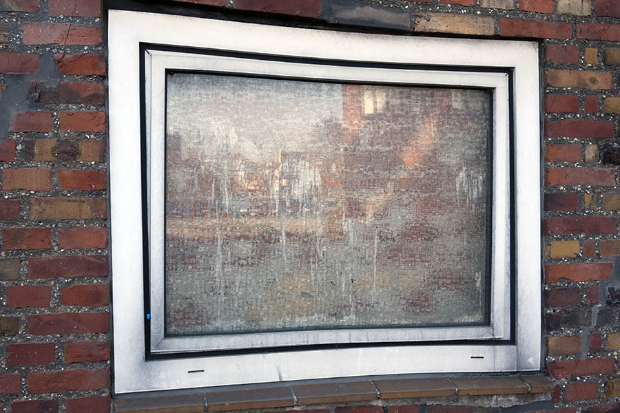 Photo 08185: Lopsided, worn, white plastic window