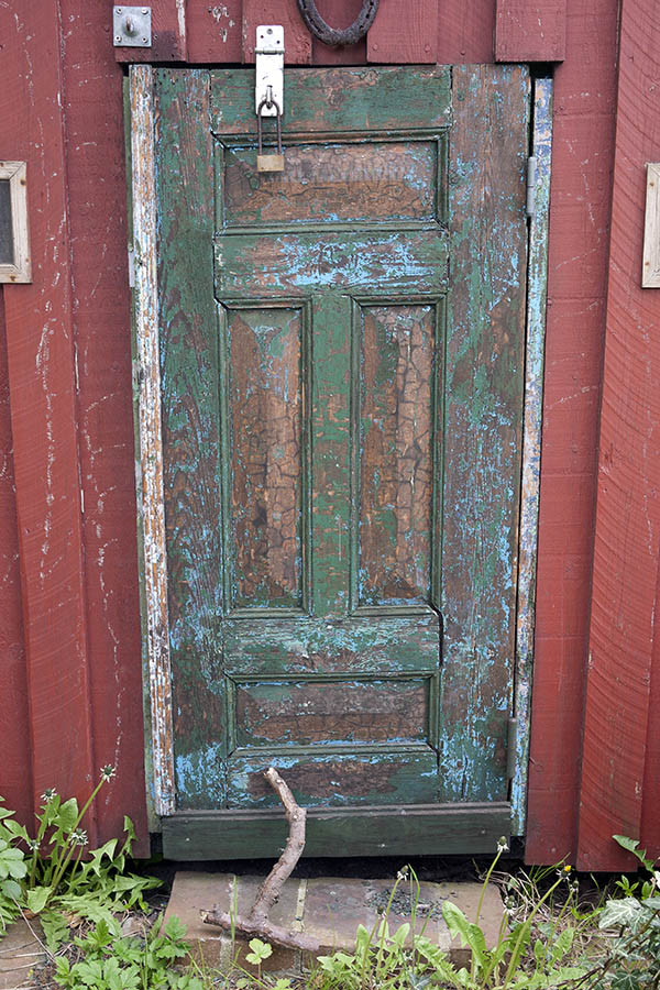 Photo 08307: Decayed, lopsided, panelled, light blue and green door