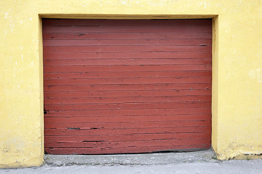 Photo 08344: Decayed, red garage door made of planks