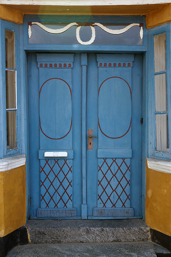 Photo 08735: Worn, carved, turquoise, red, and white double door with top window