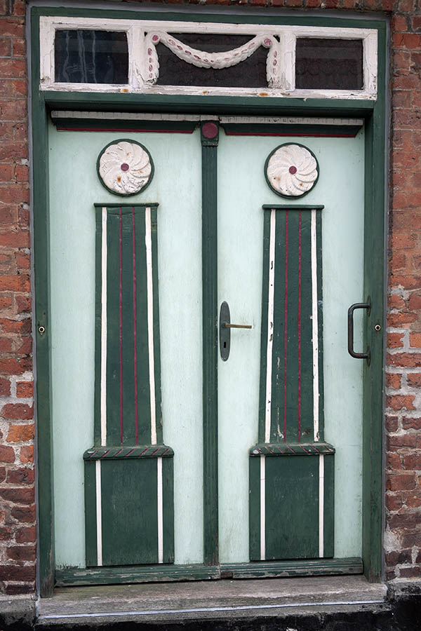 Photo 08861: Worn, carved, panelled, light green, green, white and red double door with top window