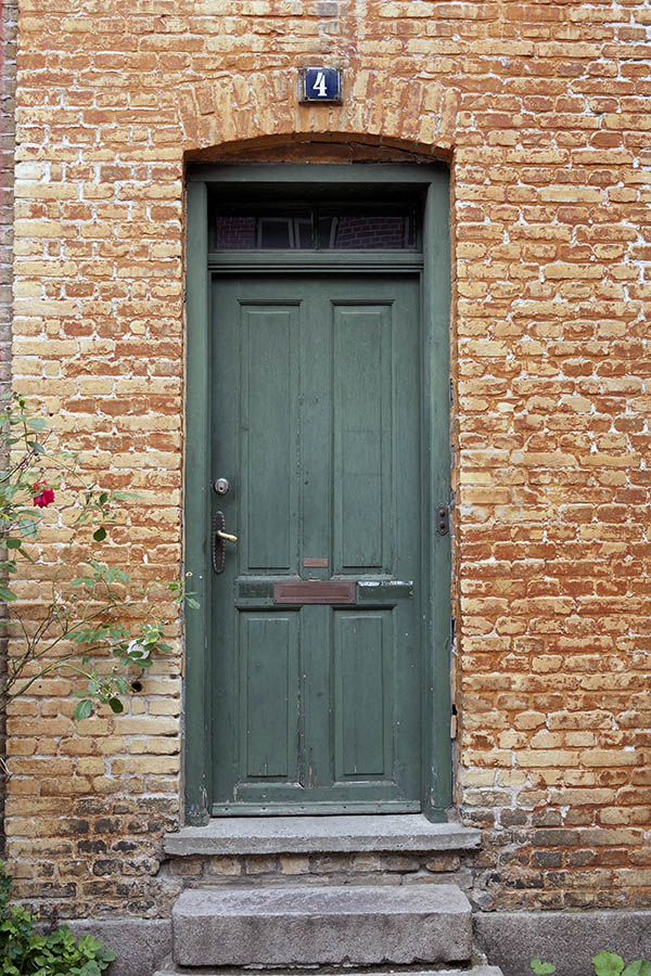 Photo 09040: Worn, panelled, green door with top window