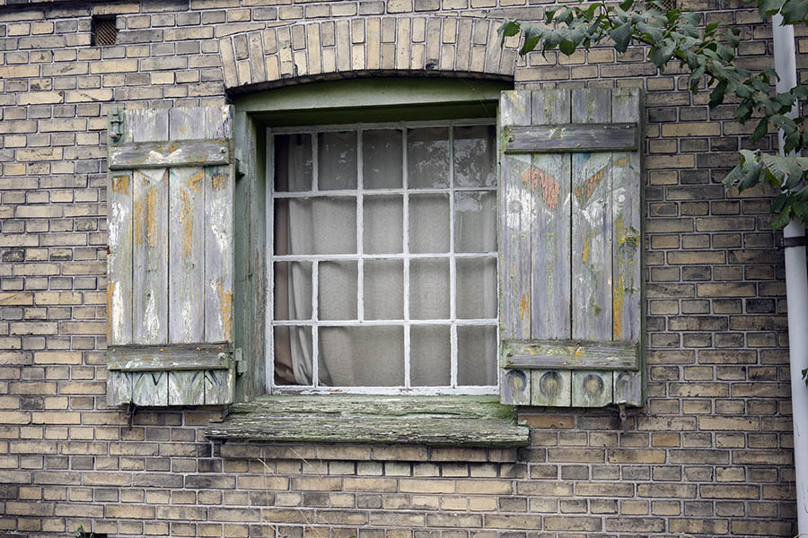 Photo 09092: Decayed, white and green window with 18 panes and shutters