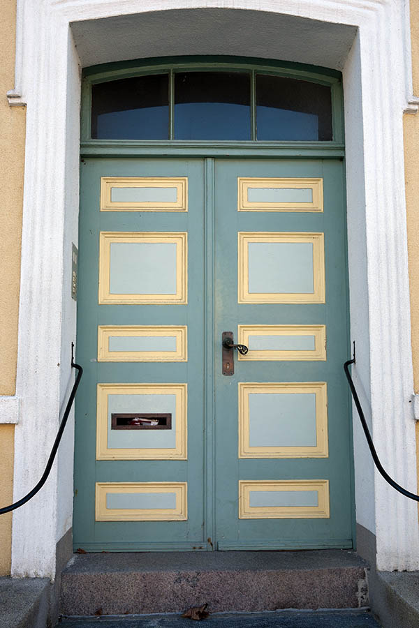 Photo 09357: Panelled, green, yellow and light grey double door with fan light and banisters