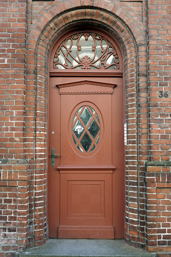Photo 09467: Carved, panelled, brown door with fan light and door light