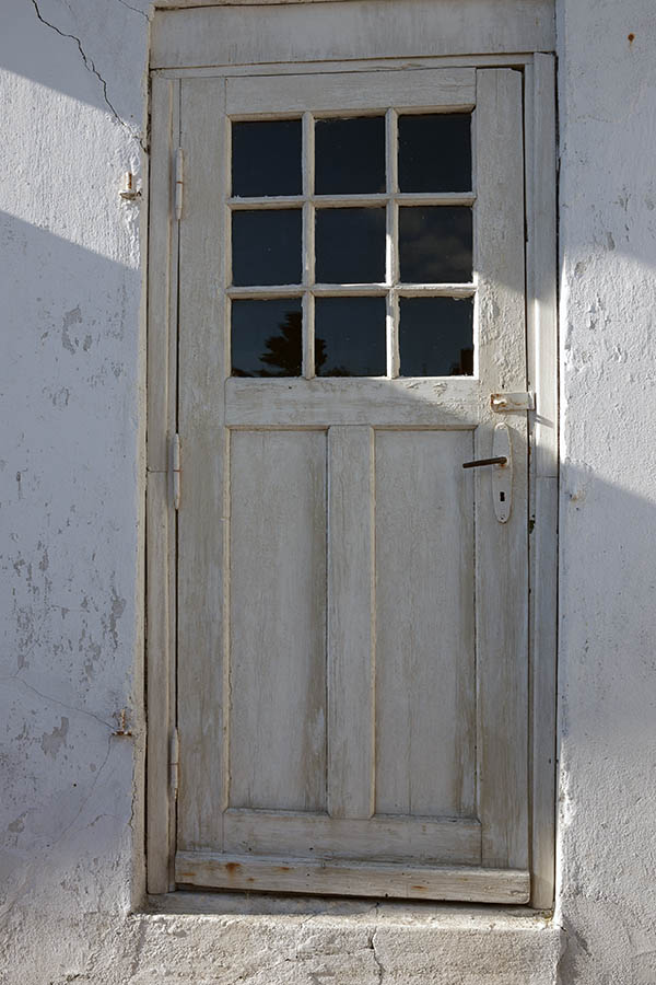 Photo 09475: Worn, panelled, white door with door light