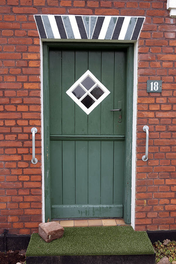 Photo 09673: Green half-door made of planks with a white, diamond-shaped door light