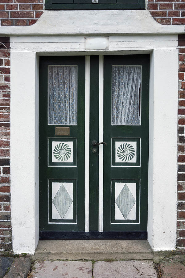 Photo 09763: Lopsided, carved, panelled, green and white double door with door lights