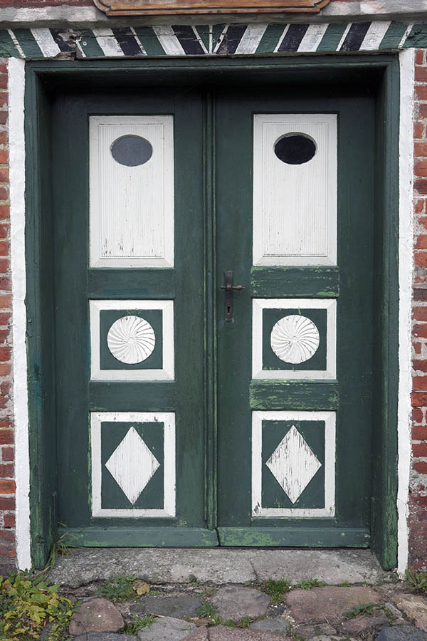 Photo 09803: Worn, carved, panelled, green and white double door with oval door lights