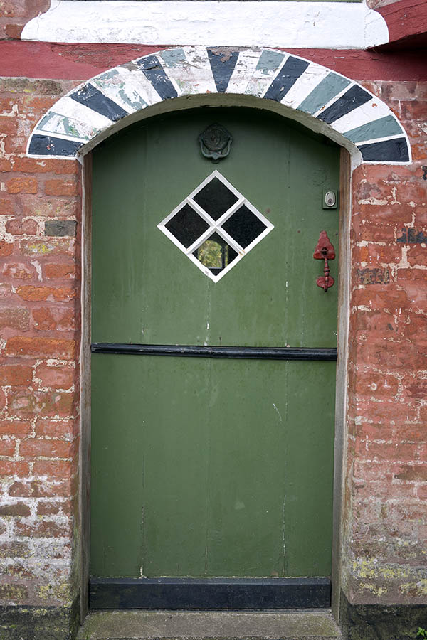 Photo 09845: Green, black and white half-door made of planks with a diamond-shaped door light