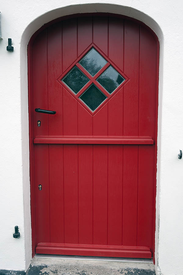 Photo 09859: Crimson red half-door made of planks with a diamond-shaped door light