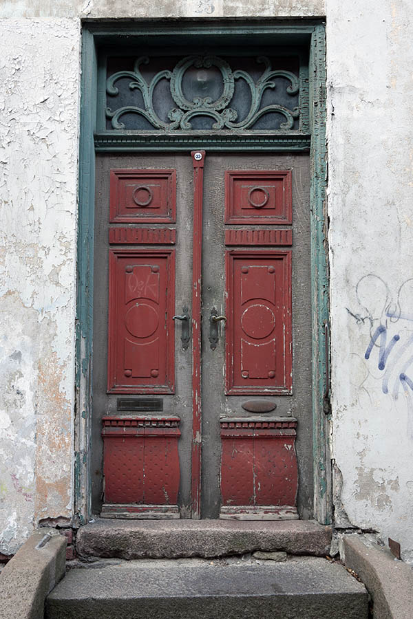 Photo 10778: Decayed, carved, panelled, red, brown and green double door with top window