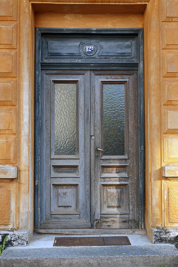 Photo 10799: Worn, panelled, teal, unpainted and brown double door with door lights