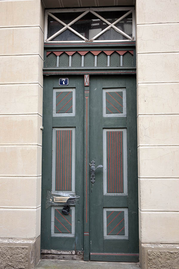 Photo 11855: Lopsided, decayed, panelled, green, red, grey and white double door with top window