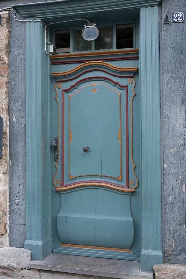 Photo 11873: Carved, panelled, teal, red and orange door with top window