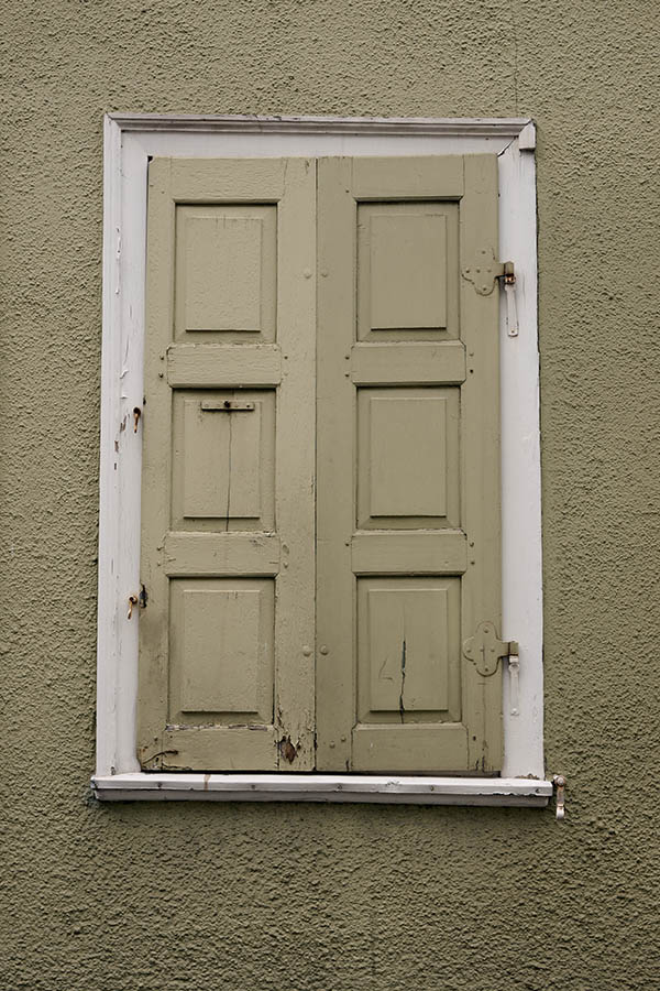 Photo 12132: Decayed, yellow shutters in a white frame