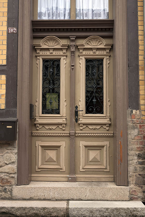 Photo 12273: Panelled, carved, brown, light brown and yellow double door with door lights and black lattice. Top 