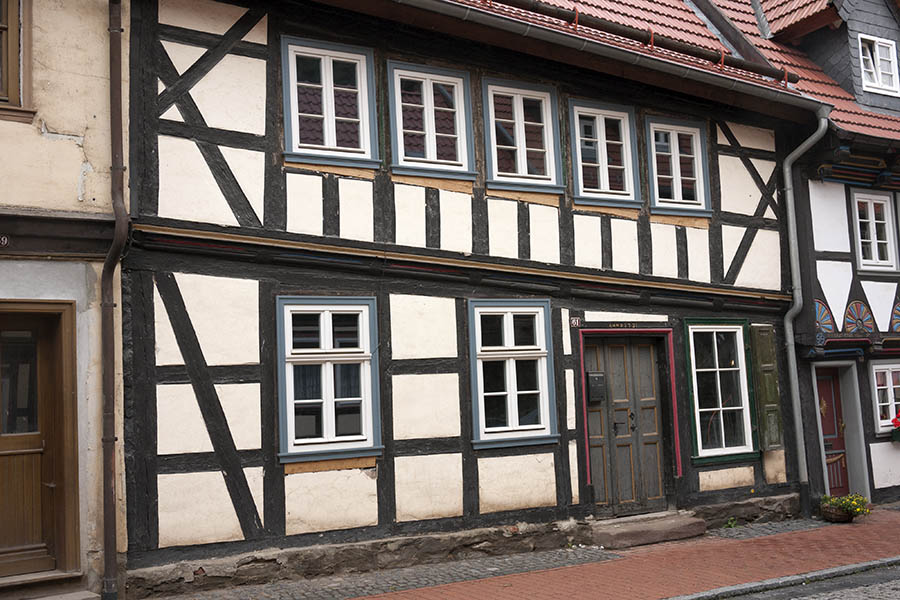 Photo 12288: Lopsided facade with eight white and blue windows and black and white half-timber