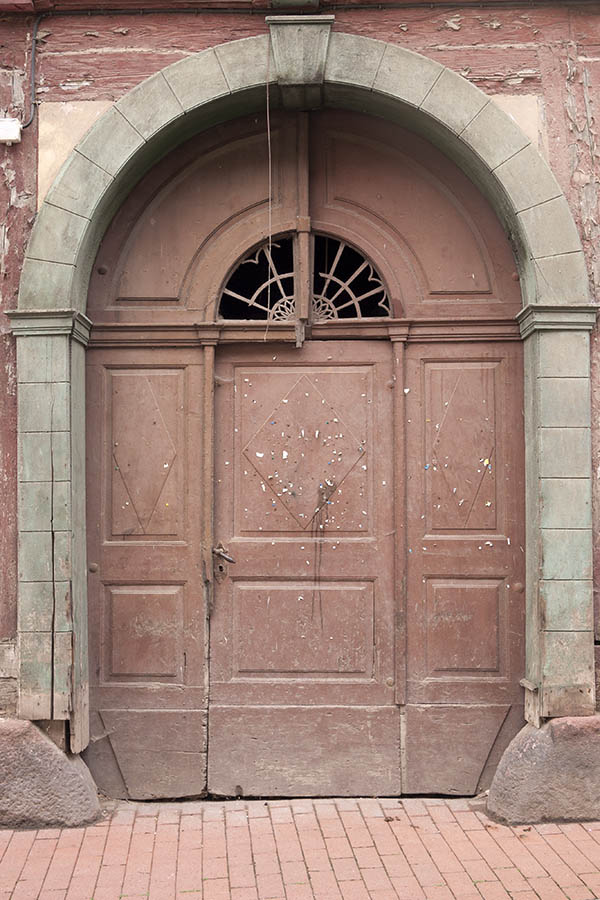 Photo 12351: Worn, panelled, light brown gate with fan light and minor door