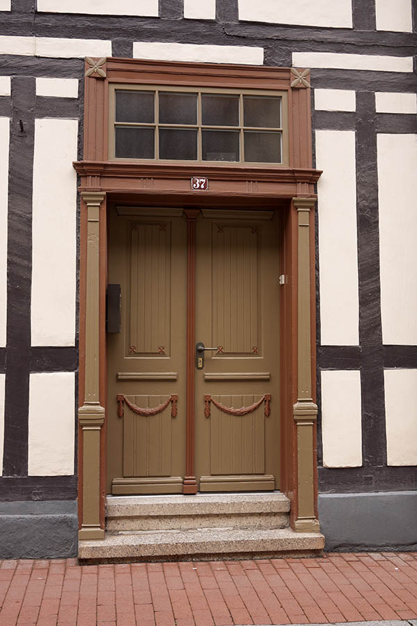 Photo 12354: Carved, panelled, brown and red double door with top window