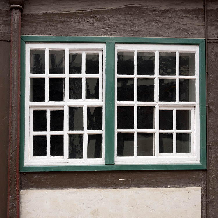 Photo 12384: Worn, green and white window with 32 panes