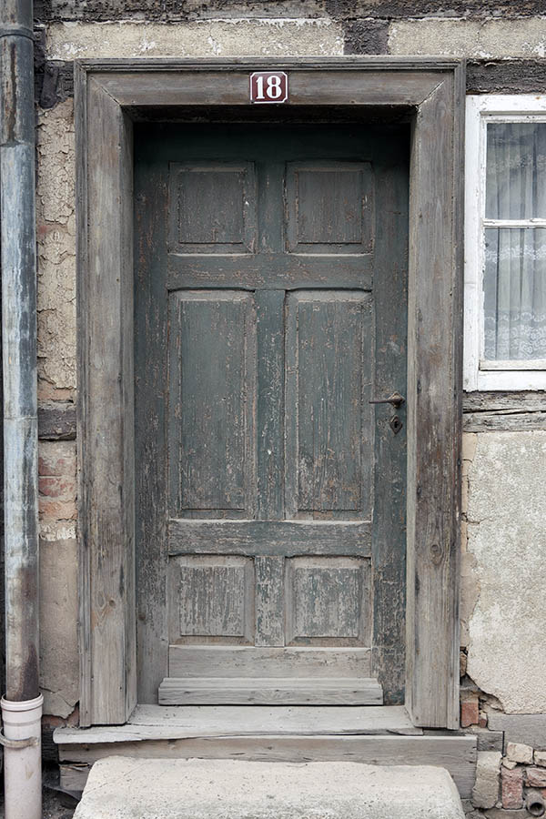 Photo 12484: Decayed, panelled, unpainted, green door