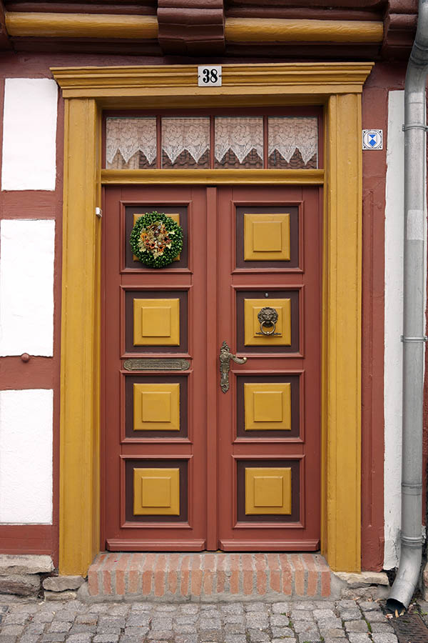 Photo 12663: Panelled, red, brown and yellow double door with top window