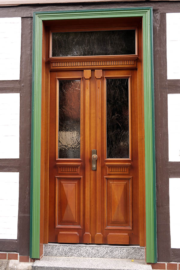 Photo 12667: Panelled, carved, red, brown and green double door with top window and door lights