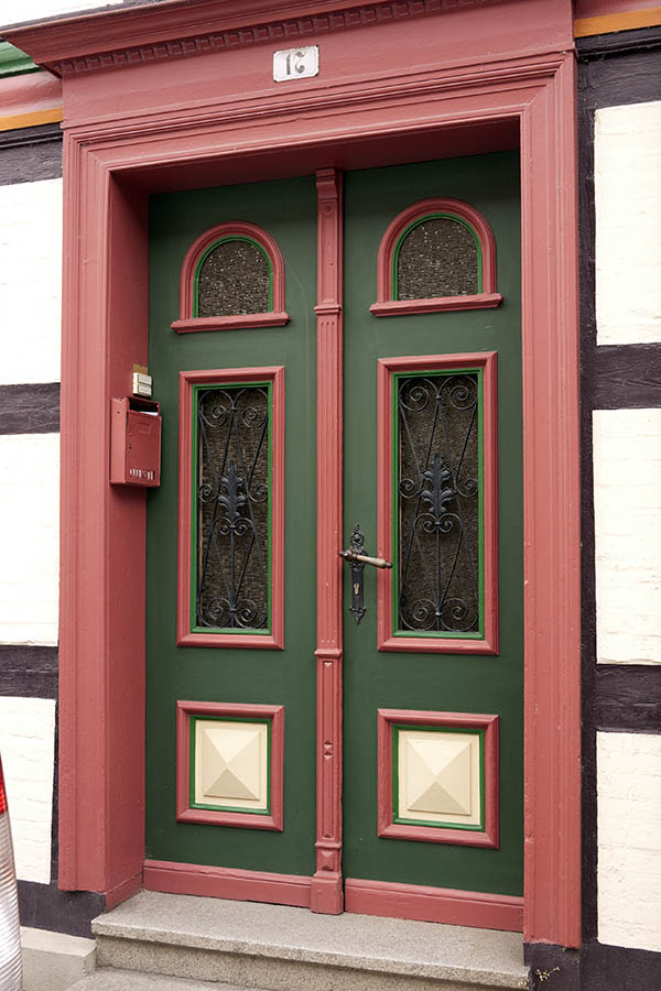 Photo 12671: Carved, panelled, pink, green and light yellow double door with formed door lights