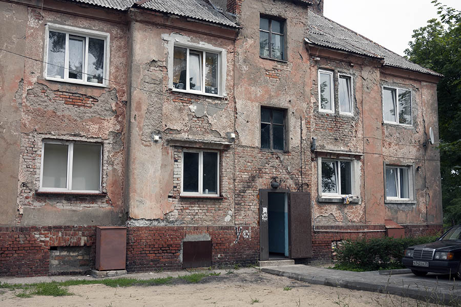 Photo 12795: Red and yellow facade with door and 10 windows