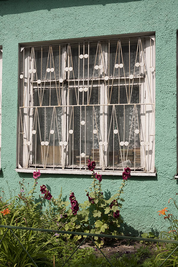 Photo 12885: Worn, latticed, white window with six frames