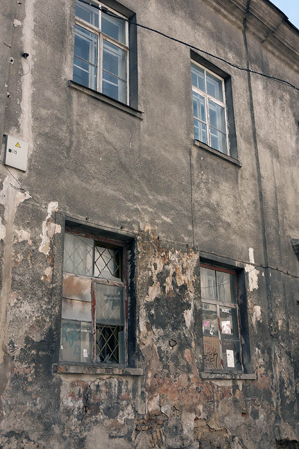 Photo 13151: Worn, grey facade with four windows