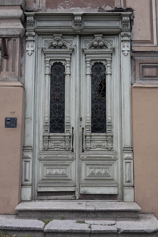 Photo 13298: Worn, carved, light grey double door with latticed door lights