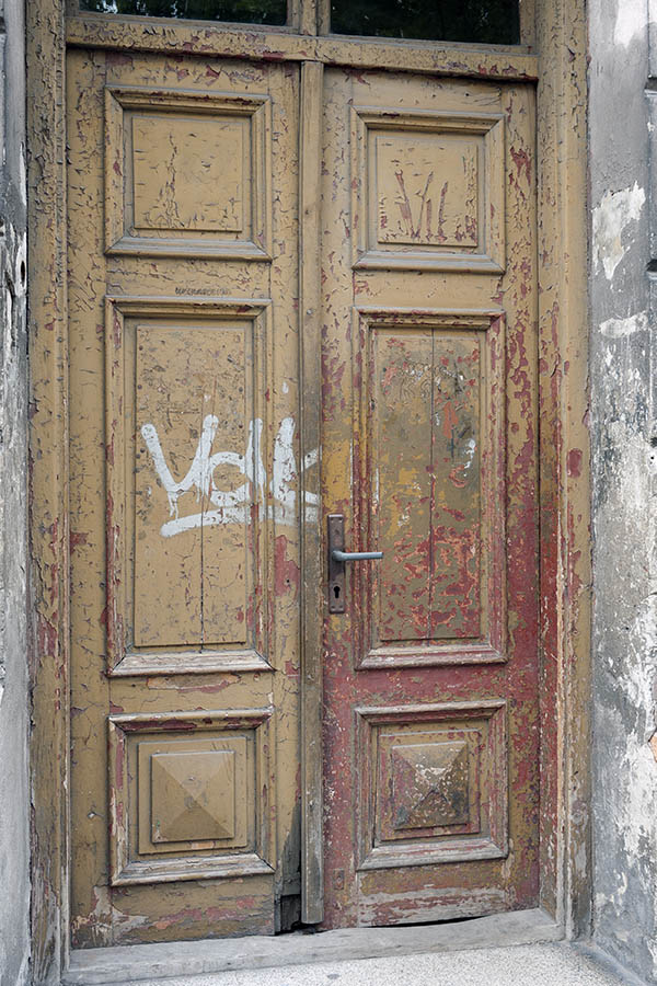 Photo 13687: Decayed, panelled, yellow and red double door with top window