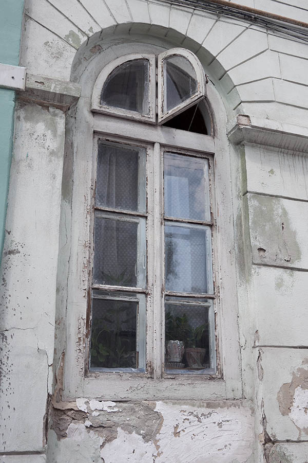Photo 13833: Worn, formed, white window with four frames and eight panes