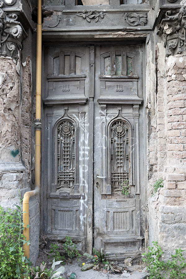 Photo 14656: Decayed, carved, panelled, grey double door with top windows