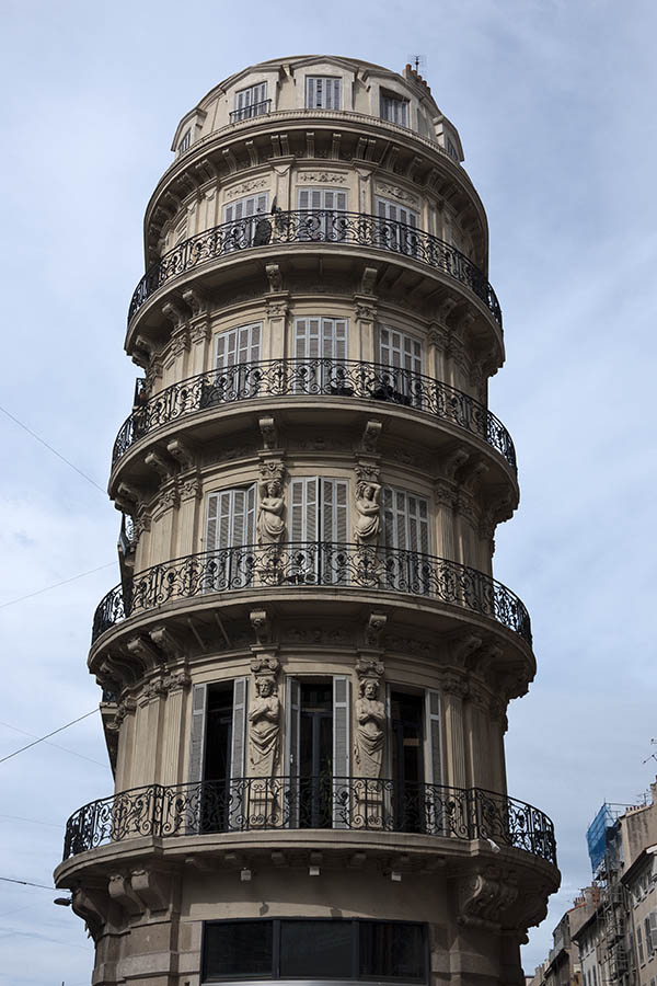 Photo 15240: Facade of round tower with many light grey shutters and black balconies