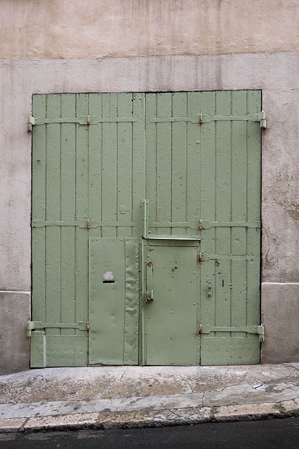 Photo 15519: Worn, light green folding gate made of planks with minor door